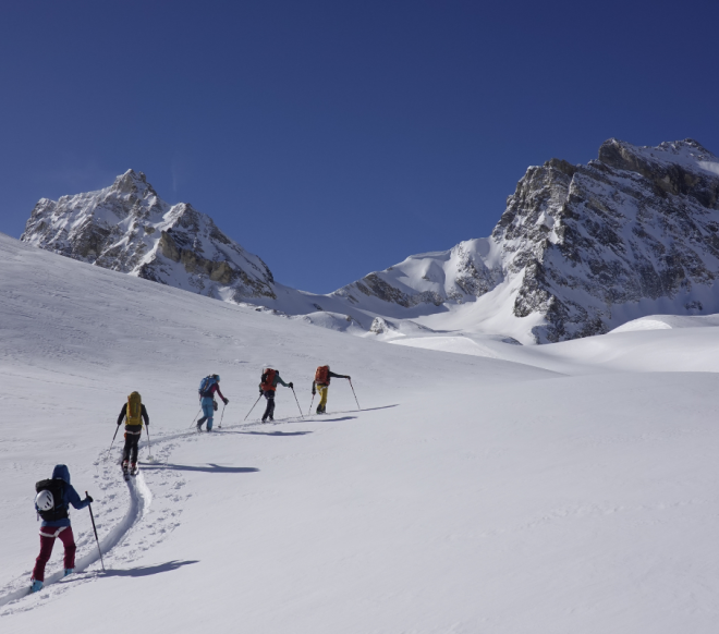 Ski touring group following the mountain guide in Val di Rhêmes